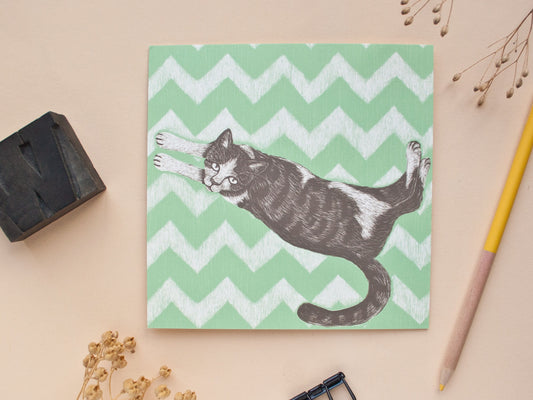 Quadratische Postkarte Katze auf Teppich
